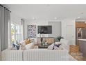 Bright living room with large windows, comfortable seating, and contemporary design at 2232 Cobble Ct # 153, Monroe, NC 28110