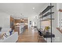 Open-concept living area flows into a modern kitchen with a large island and a cozy dining space at 2236 Cobble Ct # 151, Monroe, NC 28110