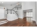 Elegant foyer with dark wood floors, a staircase with dark trim, and ample natural light at 2321 Heathershire Ln, Matthews, NC 28105