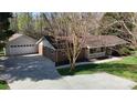 Aerial view of a brick home with a detached garage and a large driveway at 2360 Kings Grant Rd, Lincolnton, NC 28092