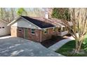 This brick home has a side entrance and a large concrete driveway at 2360 Kings Grant Rd, Lincolnton, NC 28092