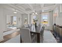 Elegant dining room with large windows, chandelier, table with seating for six at 281 Supernova Dr, York, SC 29745