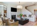 Cozy living room with fireplace, comfortable seating, stylish decor, and a large mirror accent at 5911 Wetlands Aly, Charlotte, NC 28215
