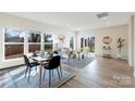 Open concept dining room with modern furnishings, large windows, and bright natural light at 713 E Third Ave, Gastonia, NC 28054