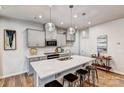 Modern kitchen featuring gray cabinets, quartz countertops, pendant lighting, and stainless steel appliances at 8027 Downy Oak Ln, Charlotte, NC 28269