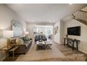 Inviting living room with a neutral color palette, wood floors, and an open layout at 8031 Downy Oak Ln, Charlotte, NC 28269