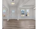 Bright living room featuring hardwood floors, large windows, and elegant trim work at 845 Regulus Ct, York, SC 29745