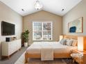 Cozy bedroom with vaulted ceiling, neutral colors, carpet, and large windows with plenty of natural light at 8804 Artesa Mill Ln, Charlotte, NC 28214