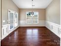 Bright dining room with hardwood floors, neutral colors, and french doors leading to the patio at 8804 Artesa Mill Ln, Charlotte, NC 28214