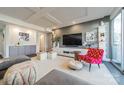 Comfortable living room with stylish gray sectional, white shelving, and a decorative chair at 1300 Reece Rd # 201, Charlotte, NC 28209