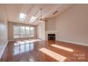 Bright living room with vaulted ceilings, fireplace, hardwood floors, and large windows at 14106 Yachtsman Harbor Dr, Charlotte, NC 28278
