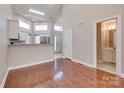 Bright living room with hardwood floors leading to an open kitchen and bathroom at 14106 Yachtsman Harbor Dr, Charlotte, NC 28278