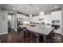 Modern kitchen boasts a large island, granite countertops, stainless steel appliances, and pendant lighting at 146 Stibbs Cross Rd, Mooresville, NC 28115