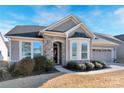 A beautiful home featuring stone accents, large windows, and manicured landscaping, providing a welcoming first impression at 1496 Imperial Ct, York, SC 29745