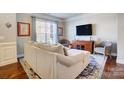 Comfortable living room with a plush sectional couch and modern entertainment center at 2024 Woodshorn Dr, Matthews, NC 28104