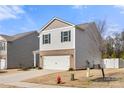 Charming two-story home featuring a brick-accented facade, attached two-car garage, and lovely curb appeal at 225 Final Stretch Ln # 19, Clover, SC 29710