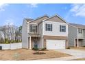 Charming two-story home featuring a brick-accented facade, attached two-car garage, and lovely curb appeal at 225 Final Stretch Ln # 19, Clover, SC 29710