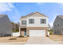 Charming two-story home featuring a brick-accented facade, attached two-car garage, and lovely curb appeal at 225 Final Stretch Ln # 19, Clover, SC 29710