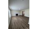 Open living area with hardwood floors, a fireplace, and plenty of natural light at 2303 Hope Valley Ln, Charlotte, NC 28213