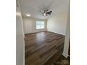 Well-lit living room featuring beautiful wood-look flooring and high ceilings at 2307 Hope Valley Ln, Charlotte, NC 28213
