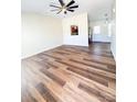 Open-concept living room with wood-look flooring leading into the kitchen at 2307 Hope Valley Ln, Charlotte, NC 28213