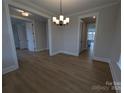 Open dining area with modern chandelier and hardwood floors at 251 Luray Way # 441, Rock Hill, SC 29730