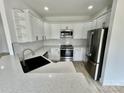 Modern kitchen features white cabinets, stainless steel appliances, and quartz countertops at 2705 Eagle Dr, Lincolnton, NC 28092