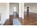 Open-concept living space with hardwood floors, white walls, and natural light at 4501 Pine Valley Rd, Charlotte, NC 28210