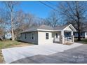 Charming single-story home featuring a covered porch with stone accents and a newly paved driveway at 533 3Rd St, Chester, SC 29706