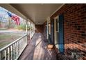 Inviting front porch featuring brick detail, white railings, and ample space for relaxing outdoors at 7210 Timber Ridge Dr, Mint Hill, NC 28227