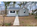 Inviting single-story home with a tidy front yard and a quaint covered porch entrance at 723 Wood St, Statesville, NC 28677