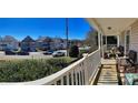 Relaxing porch view overlooking a street with neatly arranged houses and parked cars in a suburban neighborhood at 8508 Colgate Cir, Charlotte, NC 28214