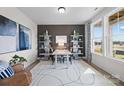 Cozy home office featuring an accent wall, stylish decor, white bookshelves, a modern light fixture, and natural light at 889 Regulus Ct, York, SC 29745