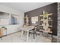Inviting office space featuring a sleek accent wall, decorative shelves, and large windows offering ample natural light at 889 Regulus Ct, York, SC 29745