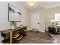 Bright foyer with modern console table, stylish decor, and hardwood floors at 9031 Pembroke Ct, Indian Land, SC 29707