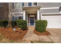 Inviting front entrance with blue door, stylish wreath, and manicured landscaping at 9031 Pembroke Ct, Indian Land, SC 29707