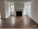 Bright living room featuring a fireplace and hardwood floors at 107 Spring View Ln, Statesville, NC 28677