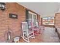 Inviting front porch with rocking chairs, detailed brickwork, and a cozy atmosphere at 111 Bethpage Rd, Kannapolis, NC 28081