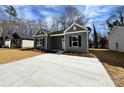 Attractive single-story home featuring gray siding, black shutters and a concrete driveway at 1116 Kenly St, Salisbury, NC 28144