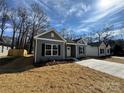 Neighborhood street view of new construction homes with grey siding, black shutters and concrete driveways at 1116 Kenly St, Salisbury, NC 28144