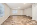 Bright living room featuring wood-look flooring, a large window, and a neutral color scheme at 1417 Pine Heart Dr, Edgemoor, SC 29712