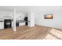 Living room with kitchen area and a mounted flatscreen television at 1641 Arlyn Cir # A, Charlotte, NC 28213