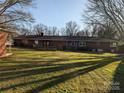 Spacious backyard featuring a well-maintained lawn and a classic brick home exterior at 1807 Brantley Rd, Kannapolis, NC 28083