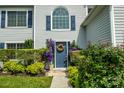 Charming front door with a wreath, surrounded by lush greenery and flowers at 2043 Covered Bridge Ct, Rock Hill, SC 29732