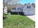 Traditional two-story home featuring a manicured lawn, attached two-car garage and inviting curb appeal at 2043 Covered Bridge Ct, Rock Hill, SC 29732