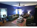 Inviting living room featuring hardwood floors, comfortable seating, and a colorful area rug at 2043 Covered Bridge Ct, Rock Hill, SC 29732