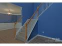 Carpeted stairs feature wood banister and leads to upper level at 2043 Covered Bridge Ct, Rock Hill, SC 29732