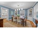 Charming dining room featuring hardwood floors, stylish lighting, and built-in shelving, perfect for gatherings at 2840 Hillsdale Ave, Charlotte, NC 28209