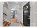 Elegant foyer with hardwood floors, archway, and stylish black door, creating a welcoming entrance at 2840 Hillsdale Ave, Charlotte, NC 28209