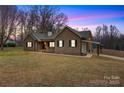 Charming brick home with a covered carport and inviting front porch, set on a spacious lawn at 4065 Lost Creek Ct, Hickory, NC 28602